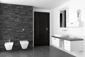 Modern bathroom with black stone wall and white equipment